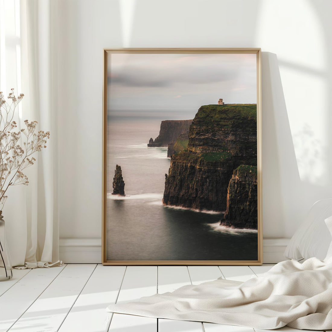 Framed Cliffs of Moher wall art print styled in a bright, natural interior space