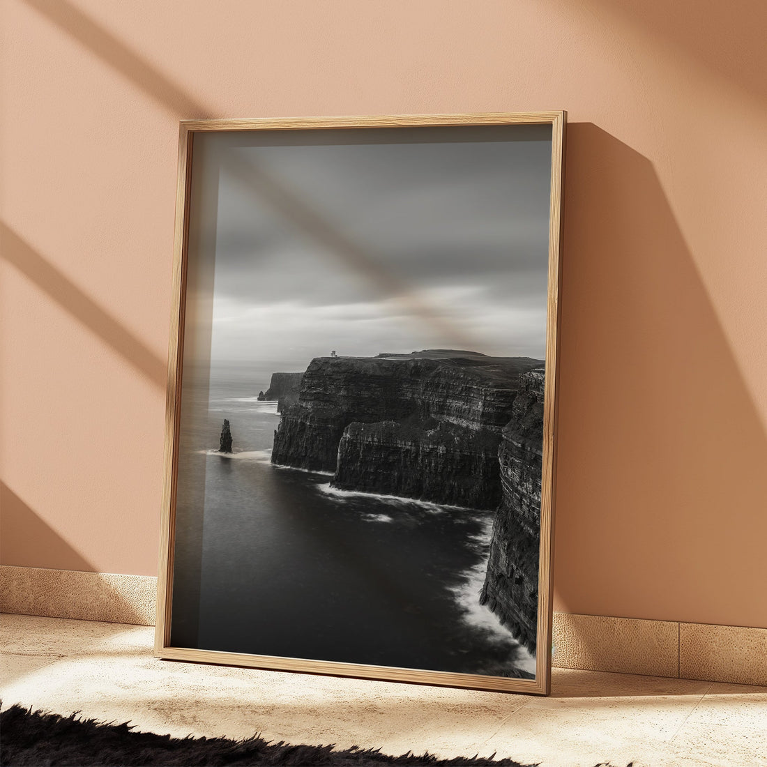 Moody lighting on black and white Cliffs of Moher print against peach wall