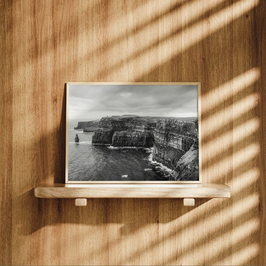 Cliffs of Moher photography displayed on a wooden shelf