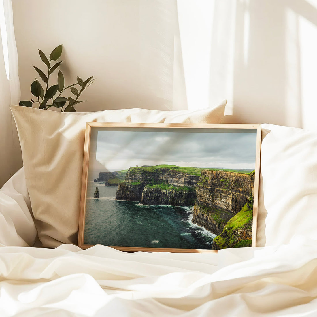 Ireland landscape photography print resting on a bed with warm natural light