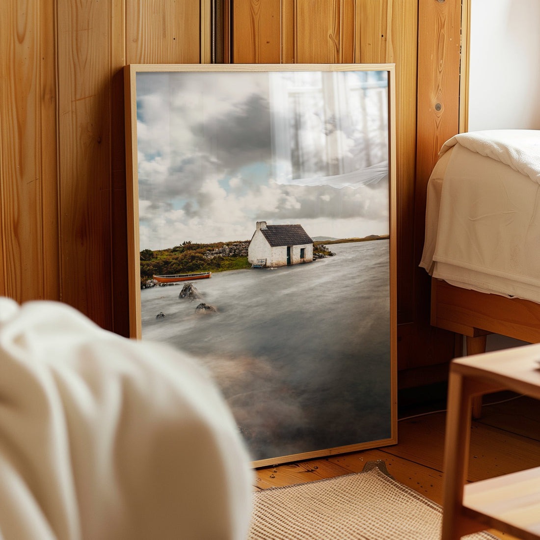 Irish bothy print resting beside bed with natural light