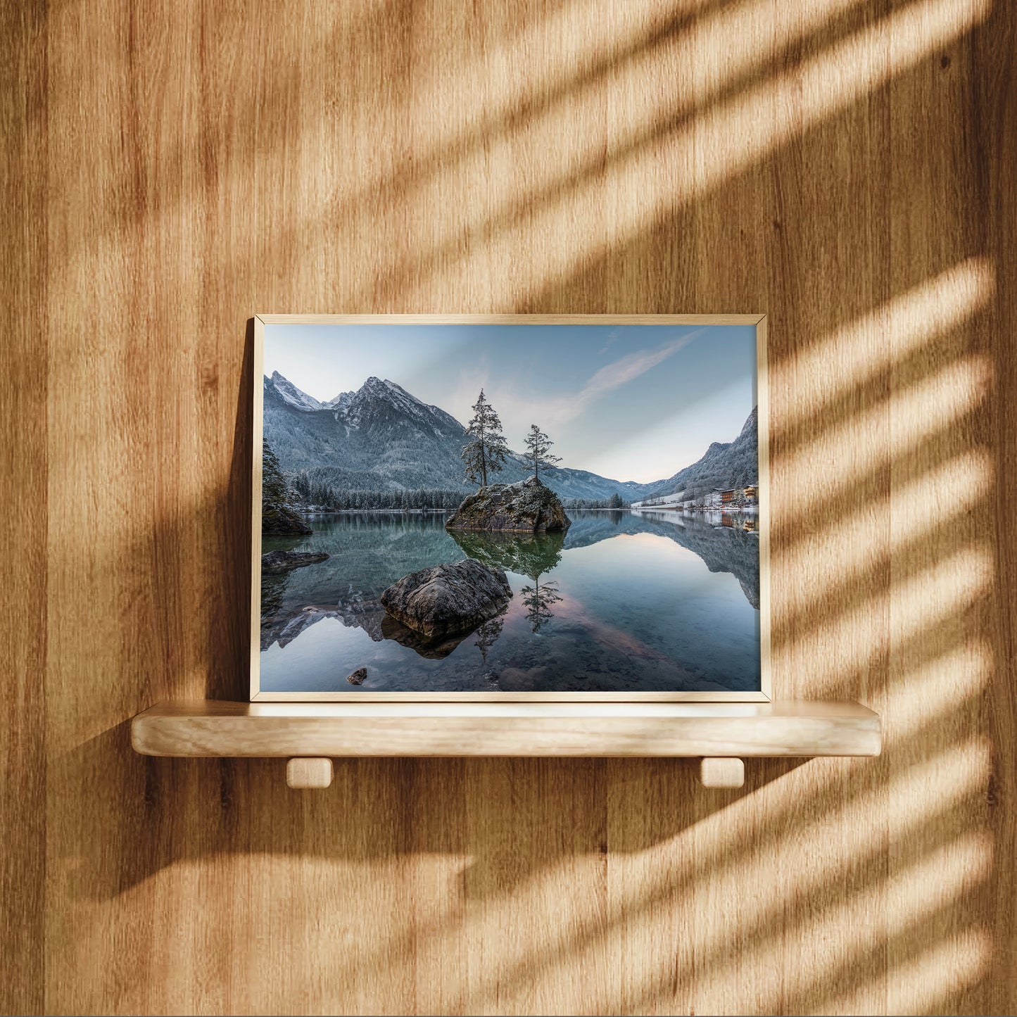 Warm-toned bedroom interior featuring sunrise landscape of Hintersee