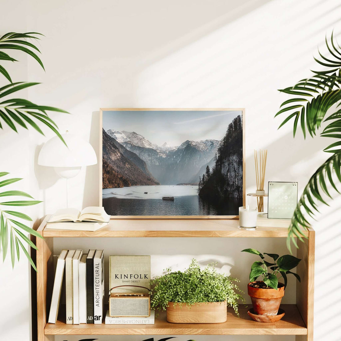 Light-filled interior featuring Königssee lake print and houseplants
