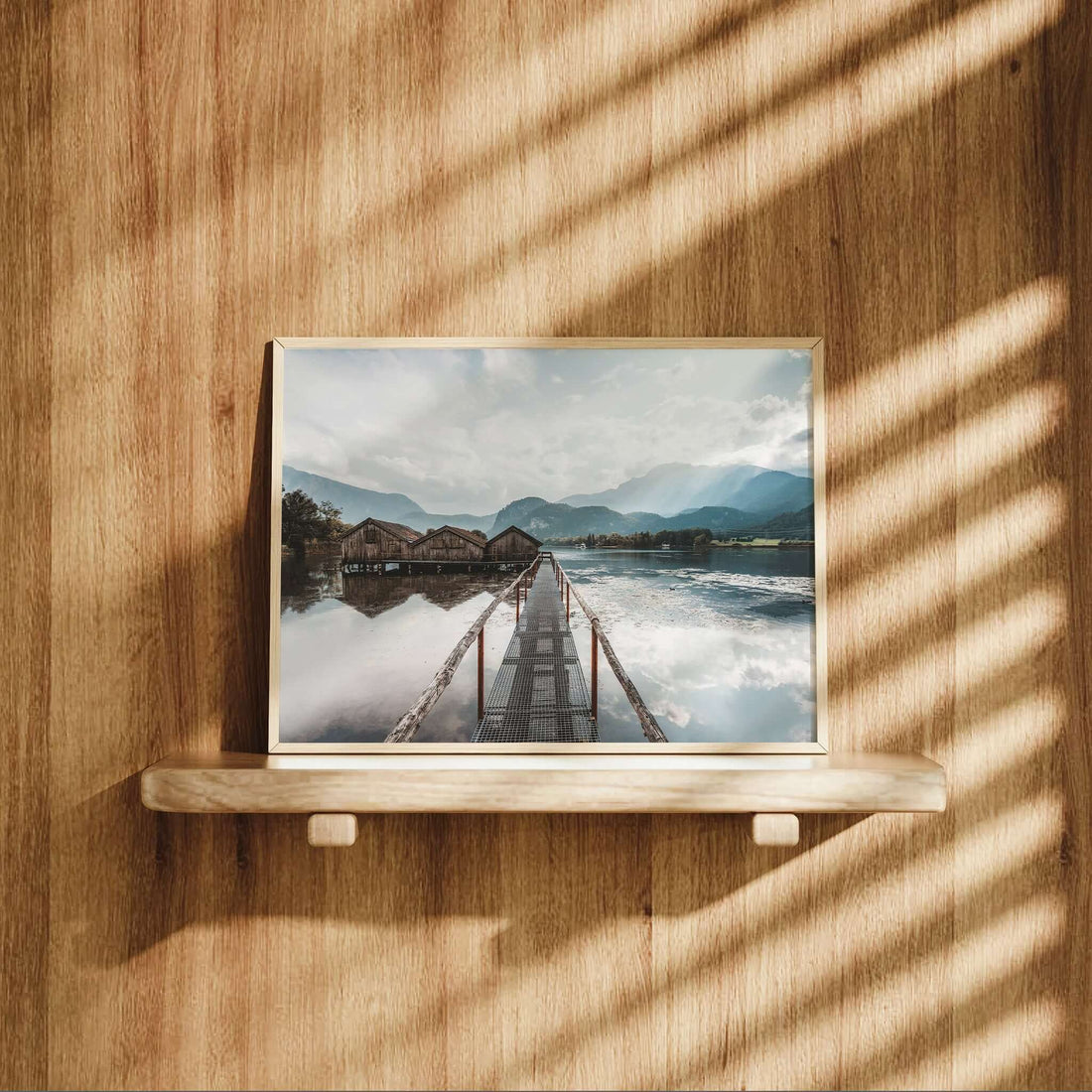 Interior styled with Kochelsee lake print showing rustic huts and reflections