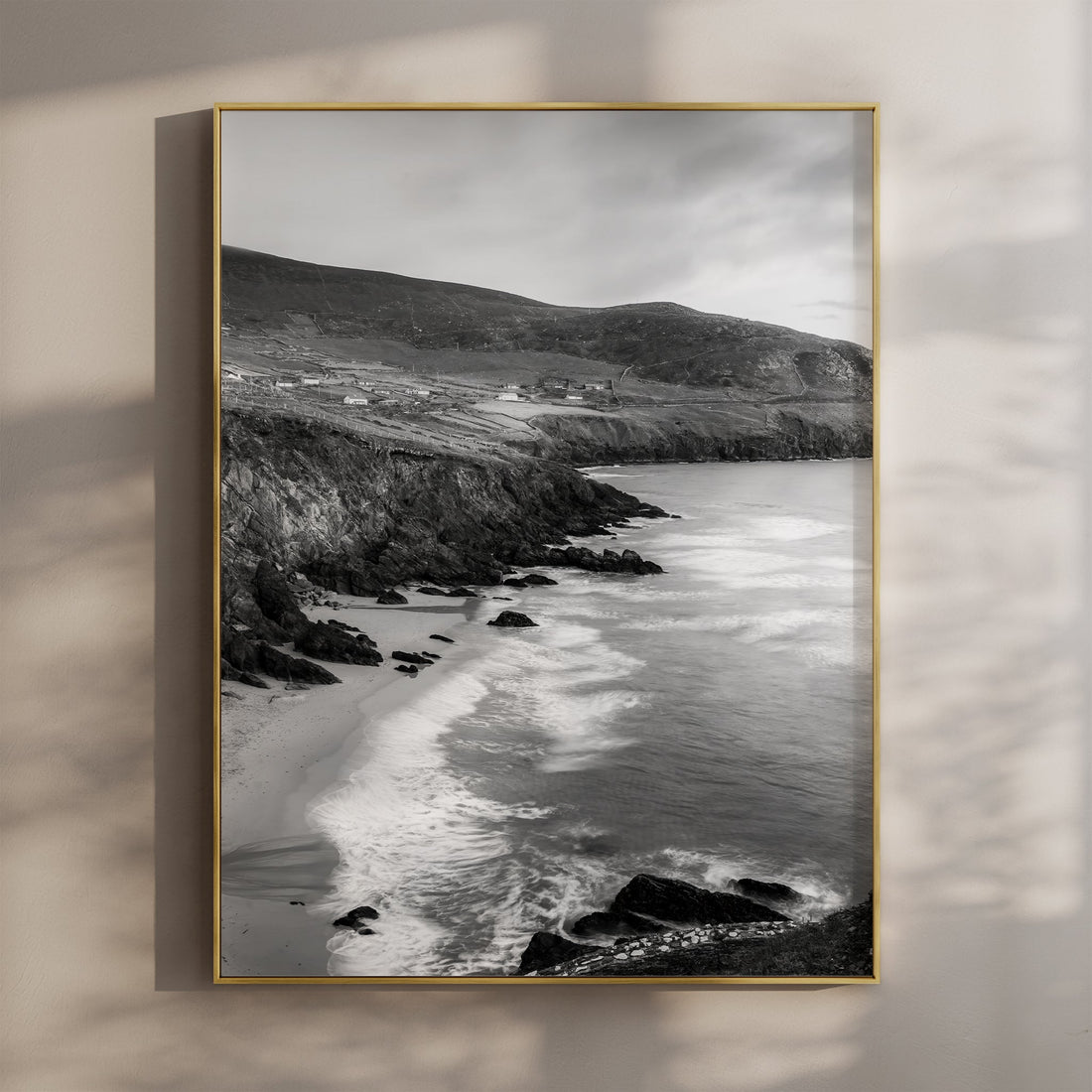 Black and white photo of Coumeenoole Beach with sea cliffs on the Dingle Peninsula