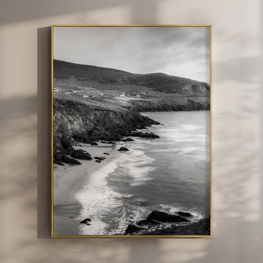Black and white photo of Coumeenoole Beach with sea cliffs on the Dingle Peninsula