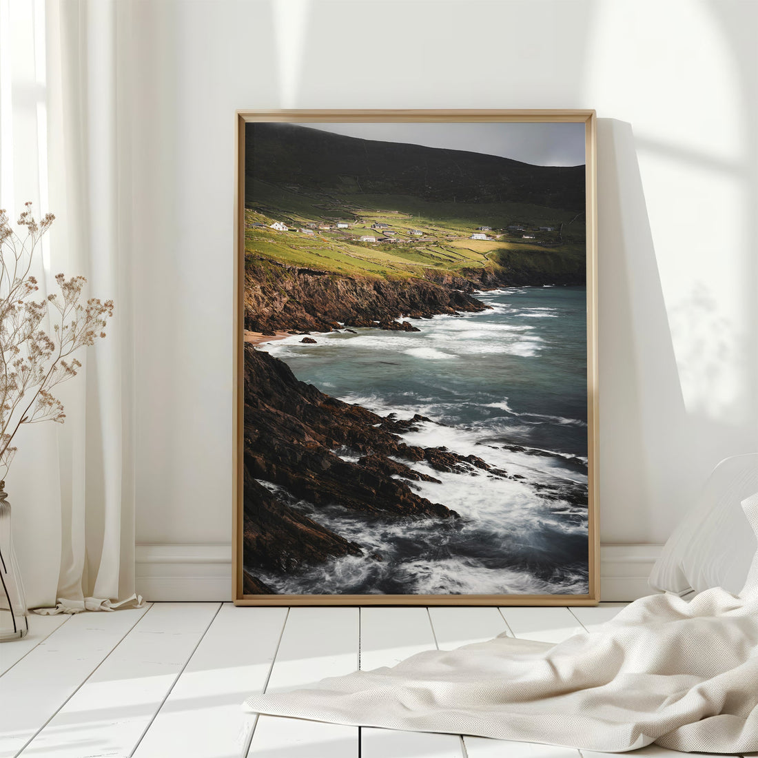 Print of Ireland's Coumeenoole Beach in soft daylight, styled on a white floor.