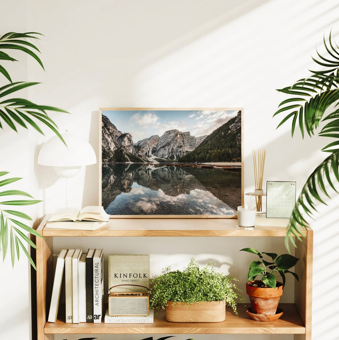 Dolomites mountain lake print on home shelf with plants and decor items