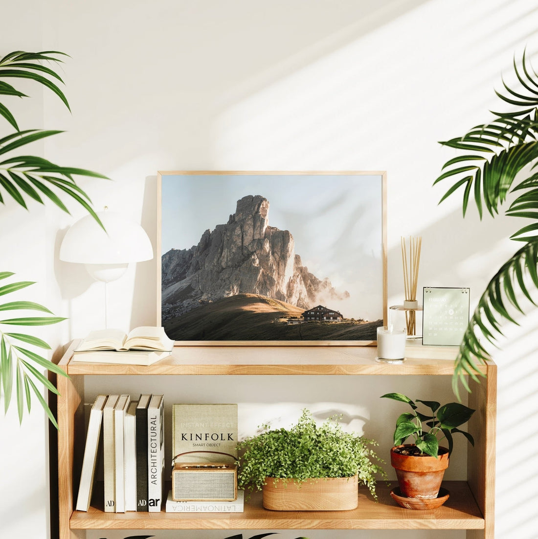 Dolomites wall art styled in a modern home with plants and books