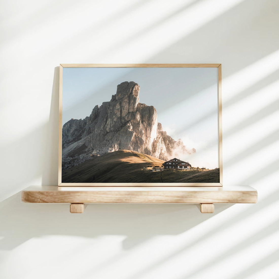 Dolomites mountain wall decor print with light tones on a minimalist shelf