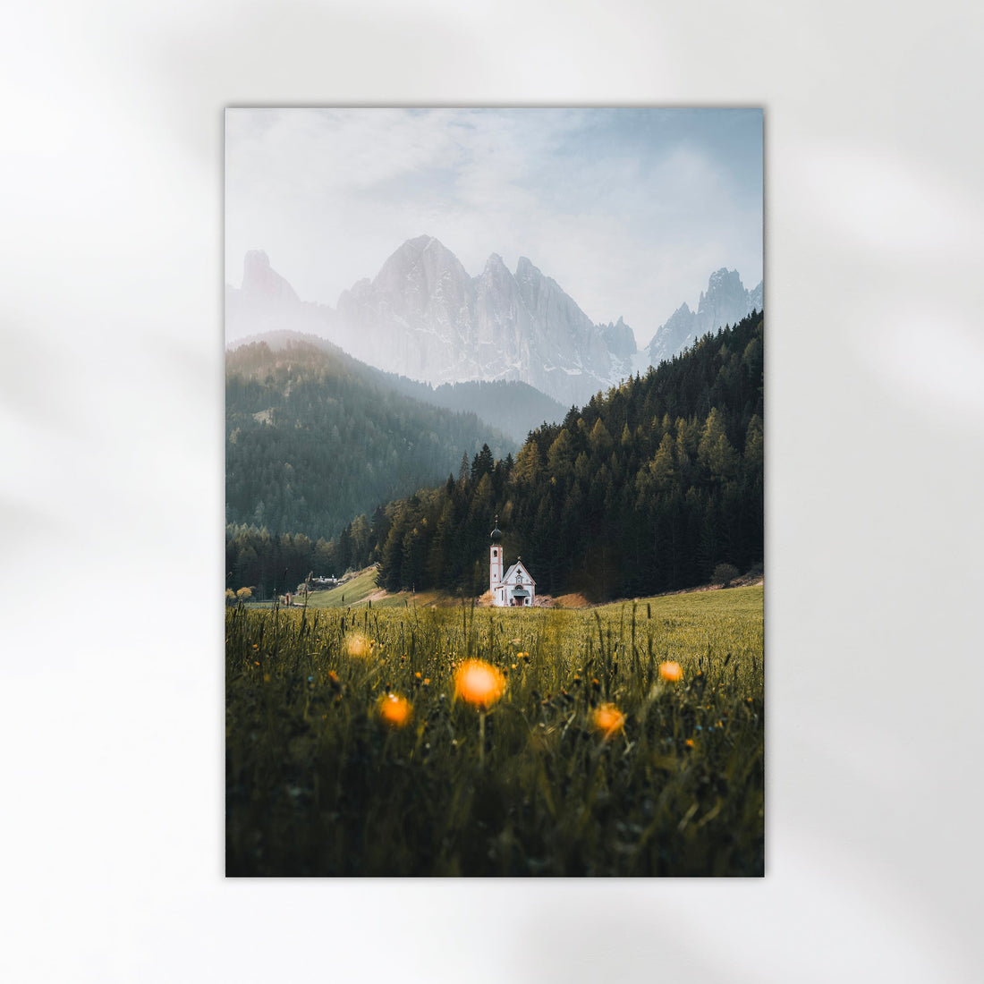 Scenic view of St. John’s Church framed by spring flowers and Dolomites mountains