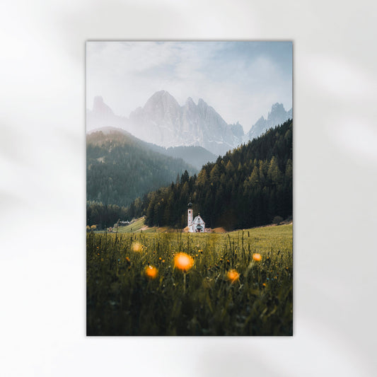 Scenic view of St. John’s Church framed by spring flowers and Dolomites mountains