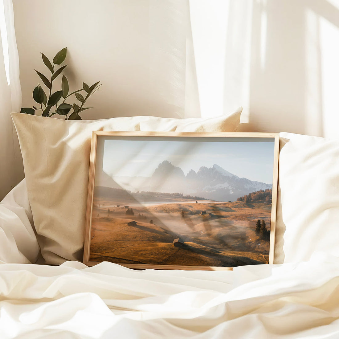 Cozy bedroom decor featuring a Dolomites wall print with warm lighting and soft mountain mist.