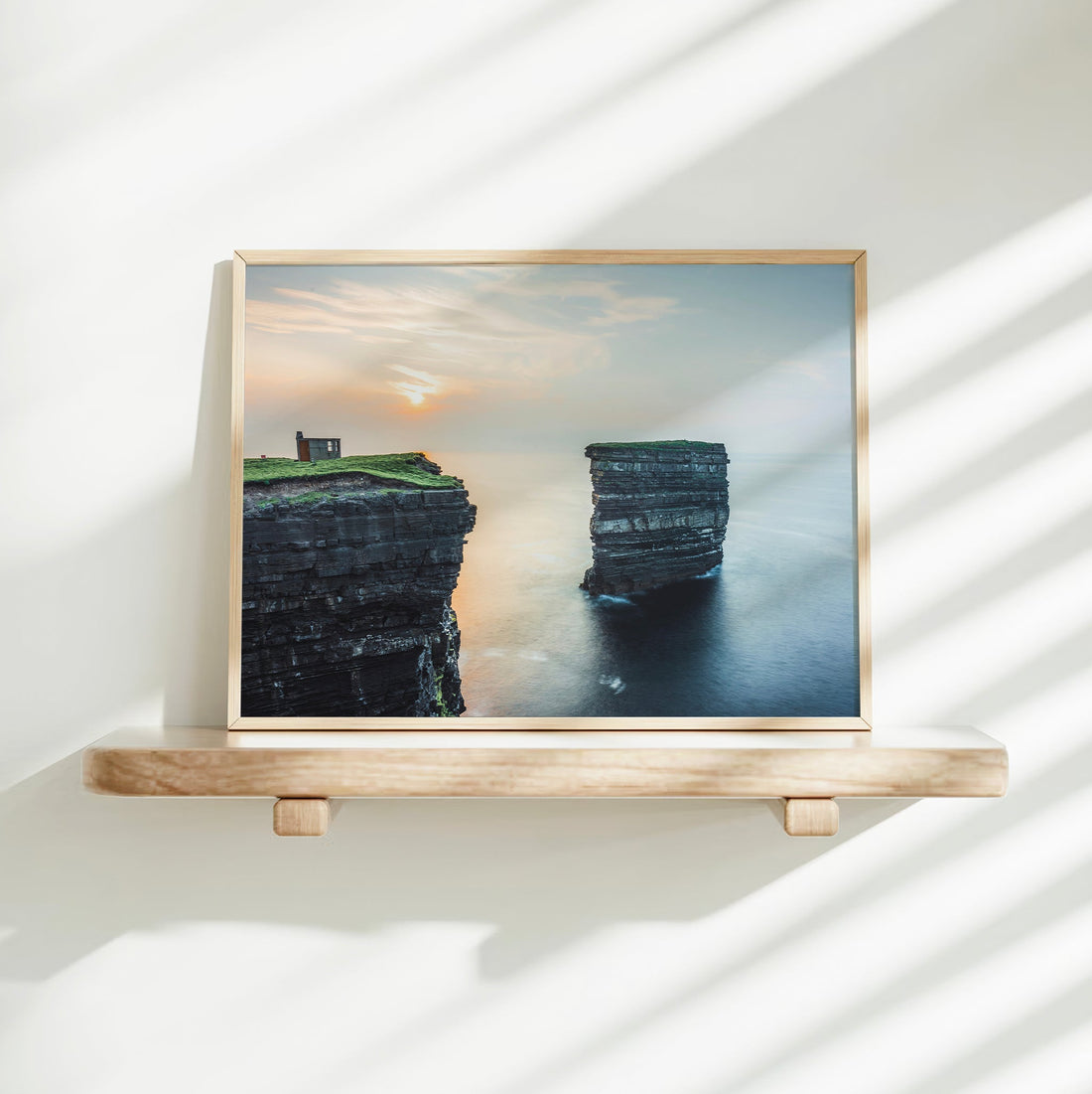 Minimal print display of Downpatrick Head sea cliffs on floating shelf with bright shadows