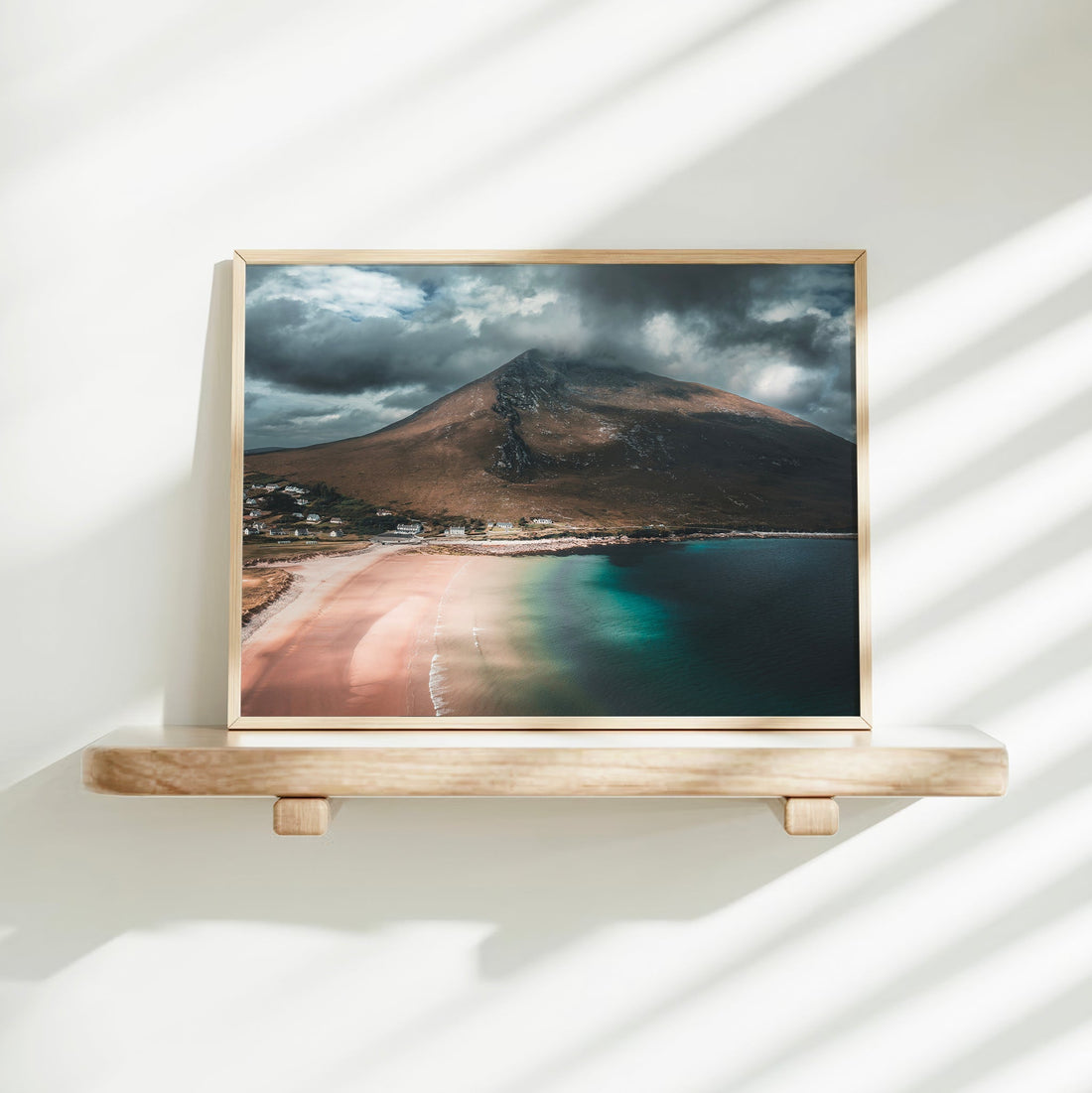 Minimalist wall shelf display of Dugort Beach landscape print in a natural frame.