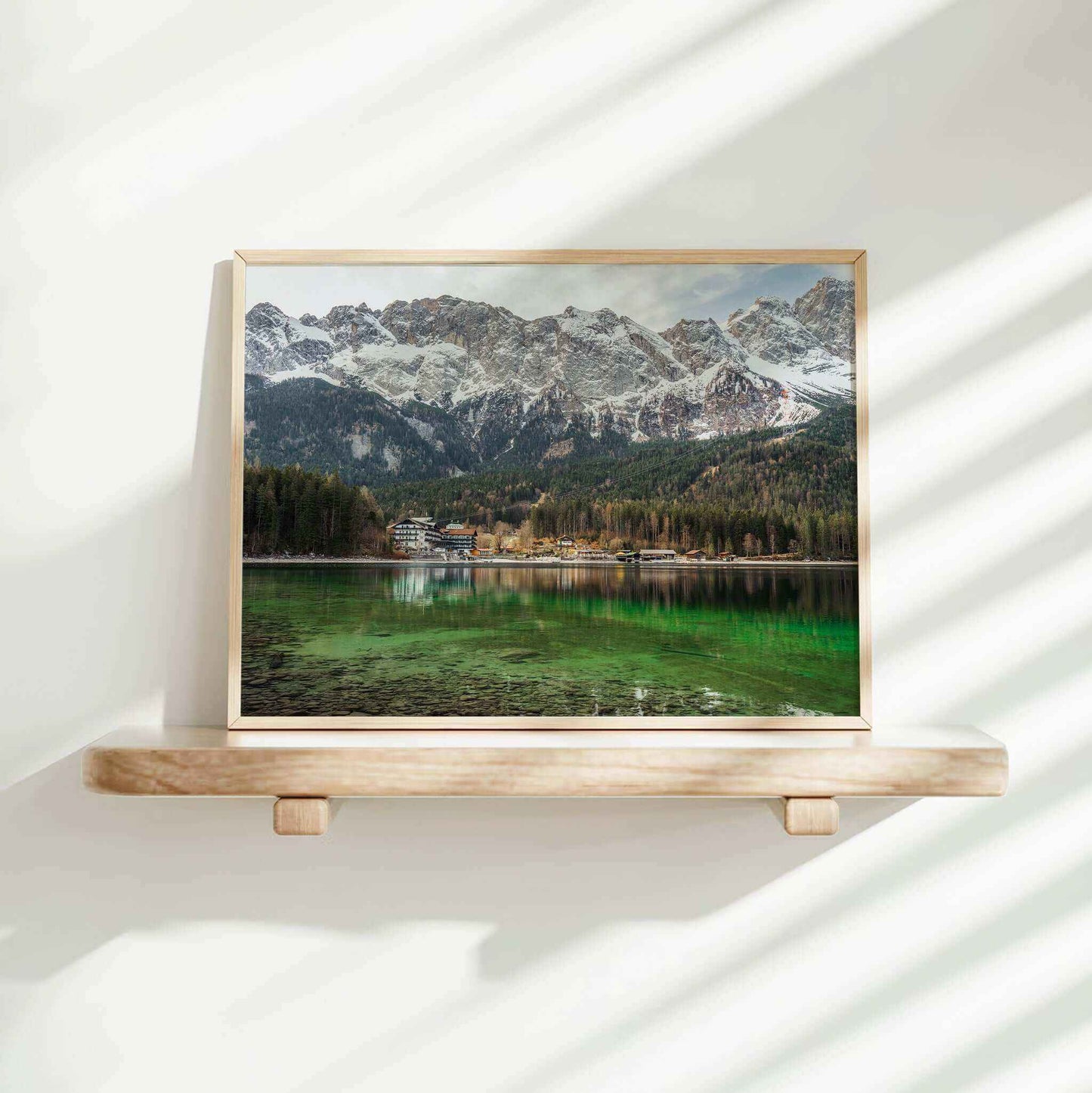 Eibsee framed art print on a shelf with green lake and dramatic alpine backdrop