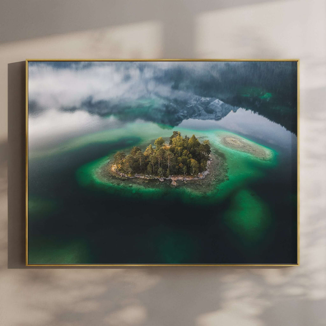 Aerial photo of a forested island in Eibsee, surrounded by emerald water