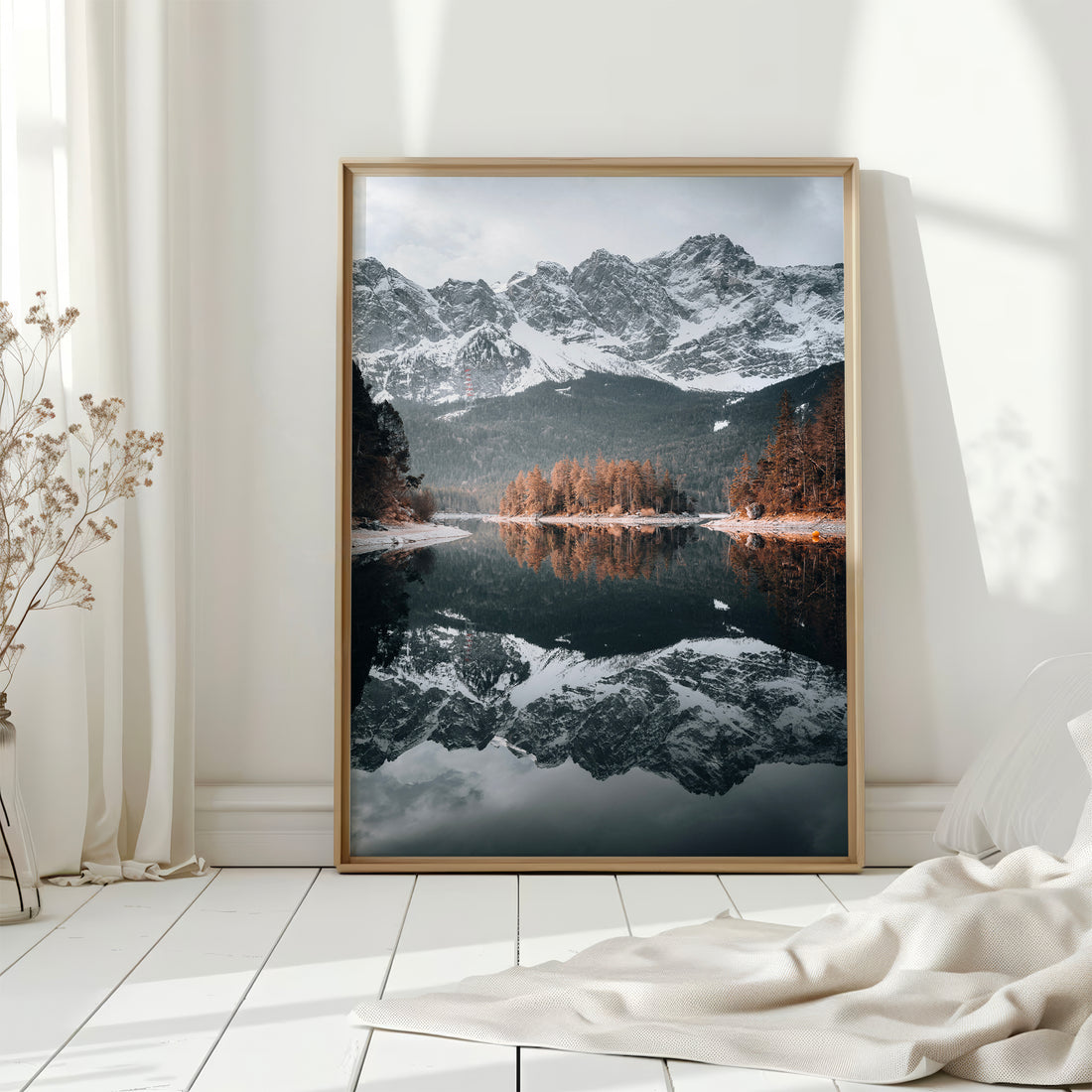 Eibsee framed print displayed on a white wooden floor with morning light