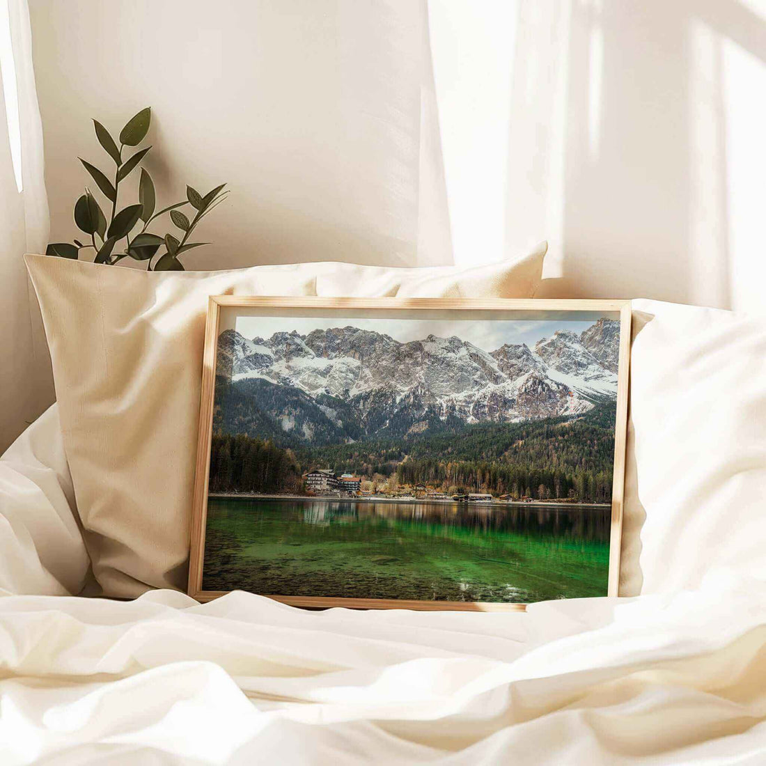 Eibsee Bavaria print resting on white bedding with warm light