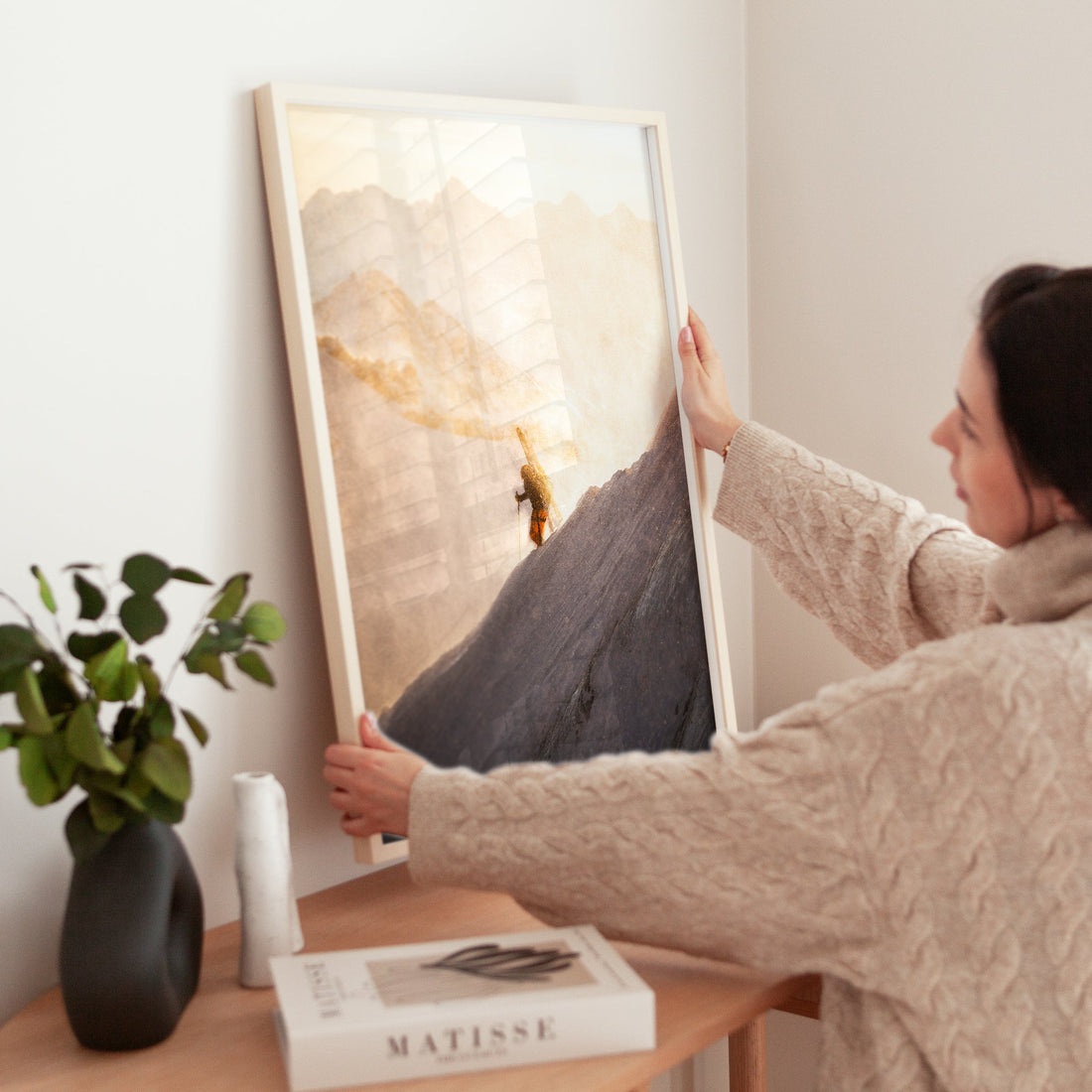 Extreme alpinism photography print of climbers making their way through deep snow under a dramatic sky.