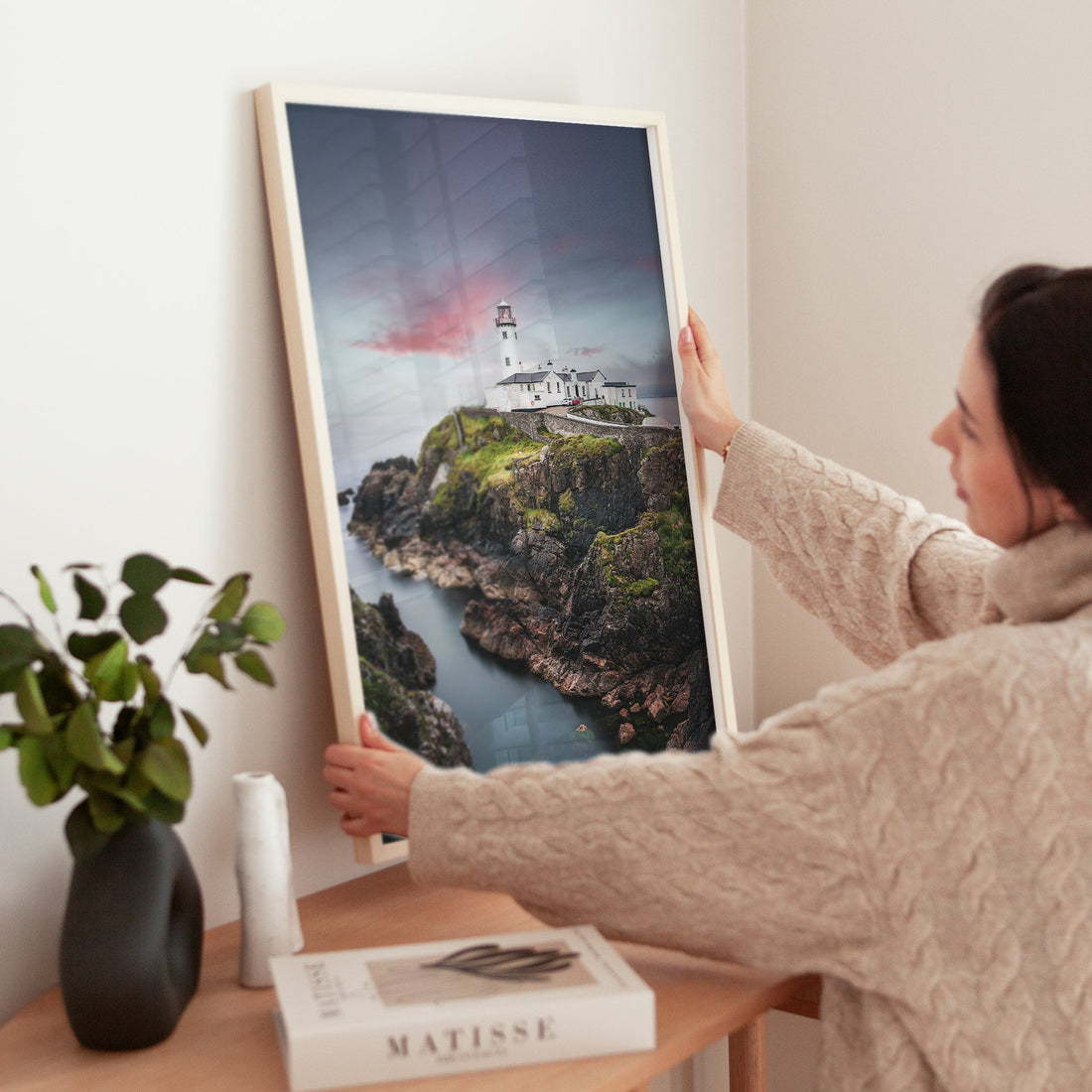 Irish seascape print of Fanad Lighthouse being positioned on shelf