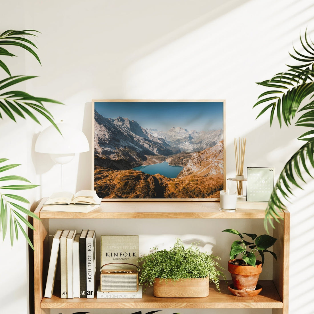 Oeschinensee lake wall art in bright room with plants and books