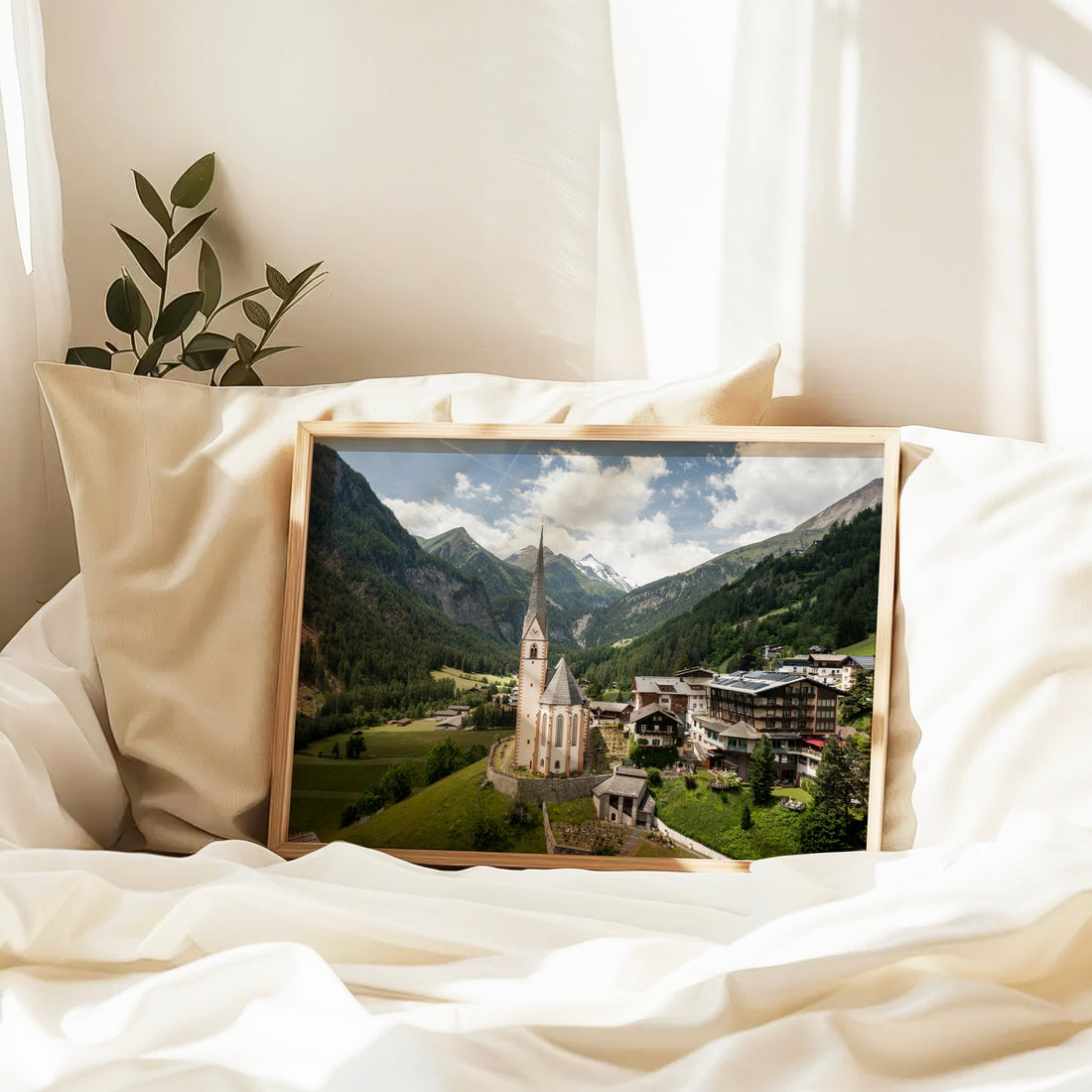 Heiligenblut church and mountains framed print resting on soft white bedding