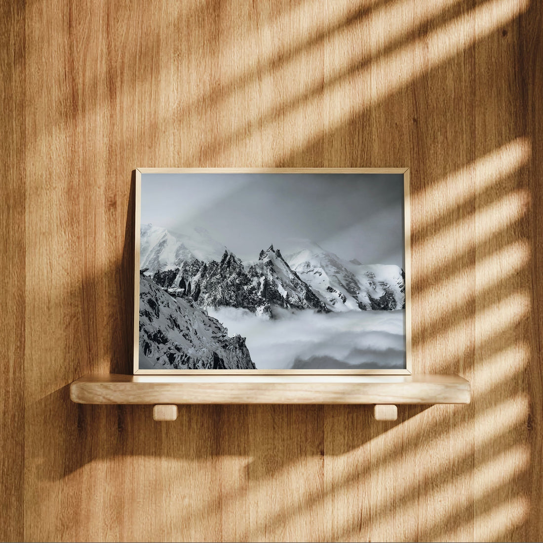 Aiguille du Midi black and white photo print displayed on a wooden shelf