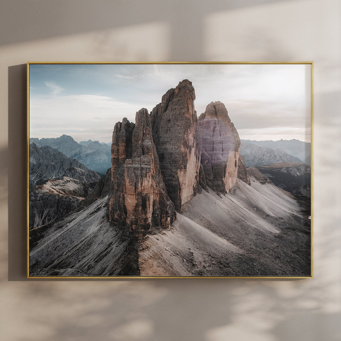 Framed photo print of Tre Cime di Lavaredo peaks at sunset, displayed on wall