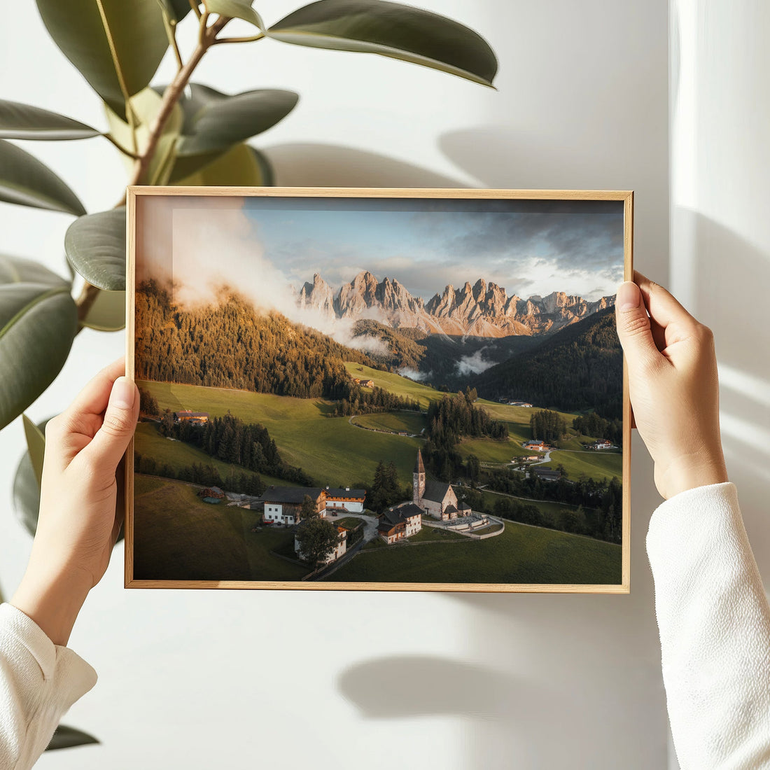 Hands holding framed St. Magdalena Dolomites print, ideal for gifting