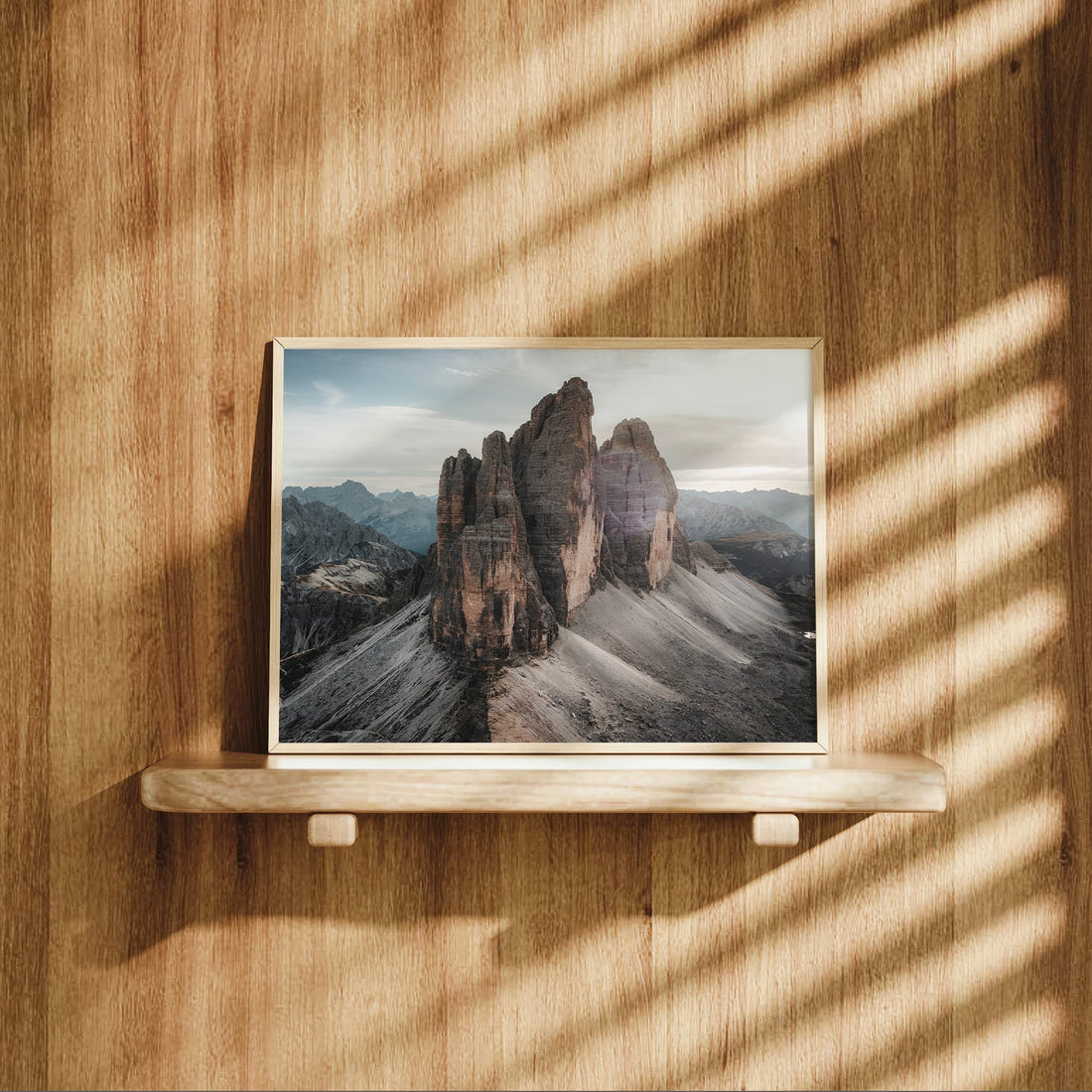 Tre Cime photo print styled on wooden shelf with mountain light and shadows