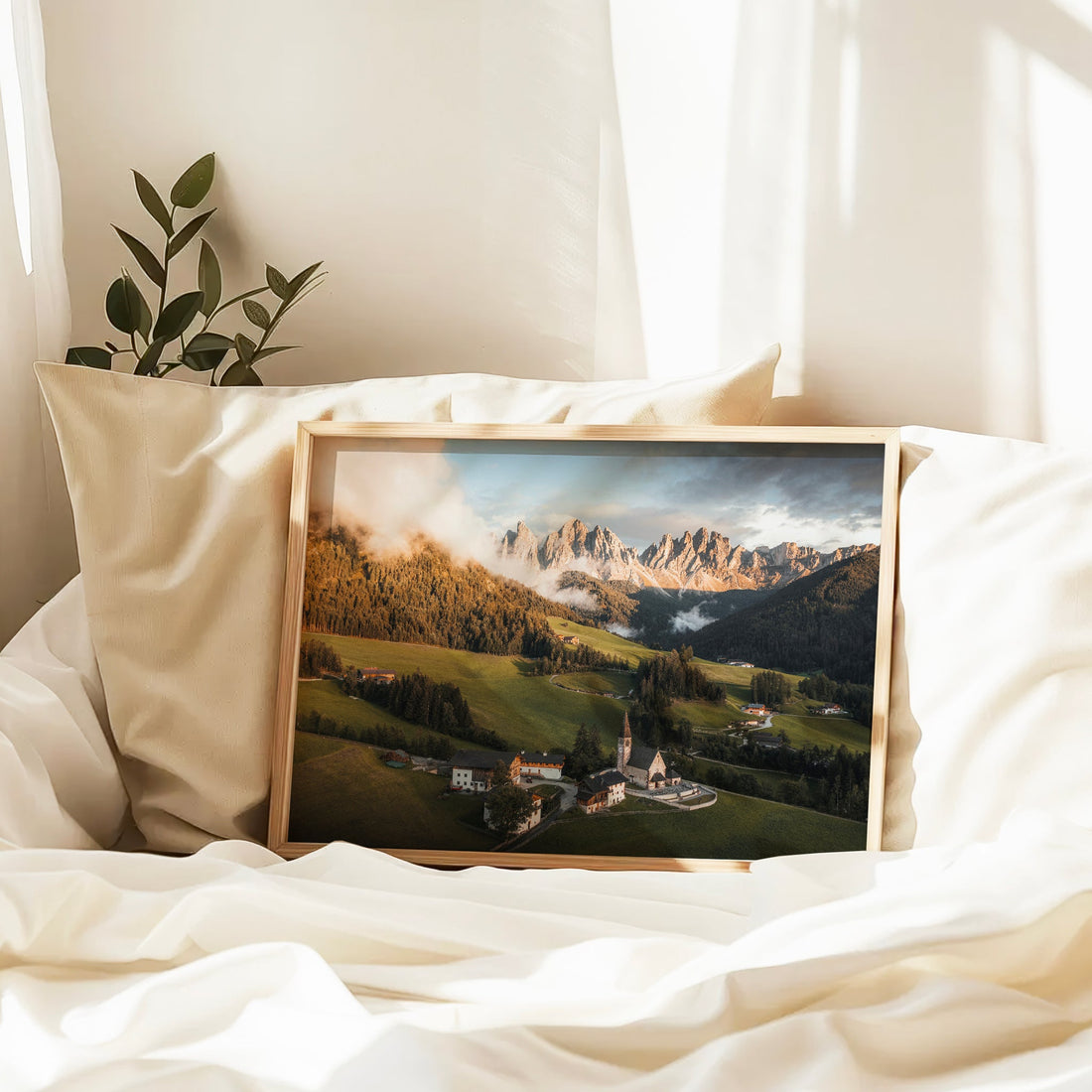 St. Magdalena framed print resting on bed in soft morning light