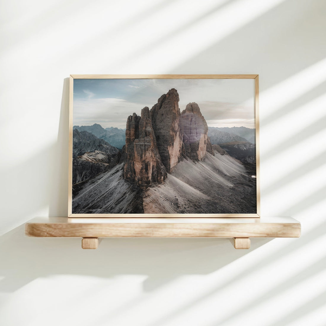 Tre Cime Dolomites wall art on shelf in minimalist space with soft morning shadows
