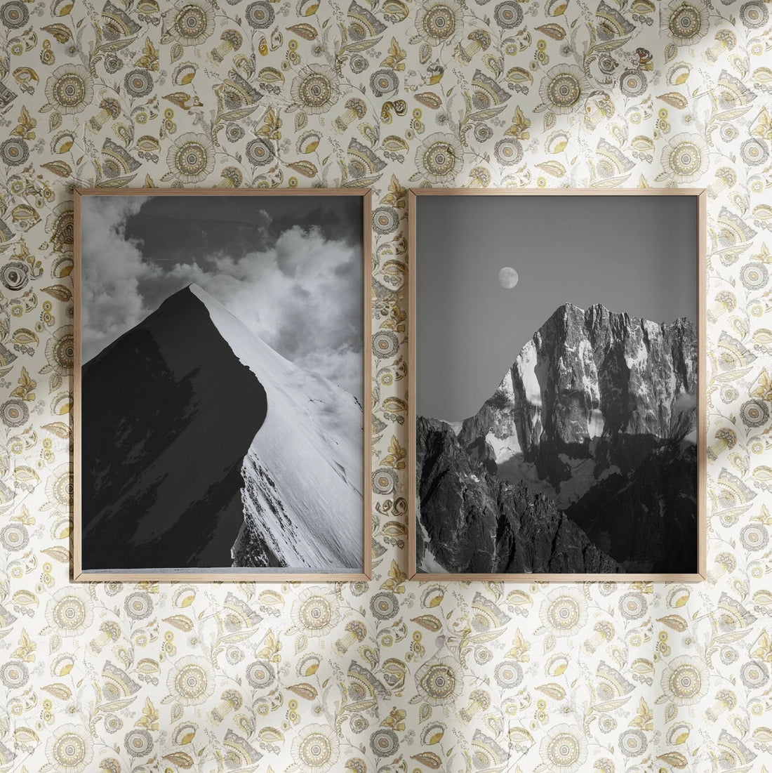 Framed prints of Aiguille de Bionnassay and Grand Jorasses against a patterned wall in an artistic setup.