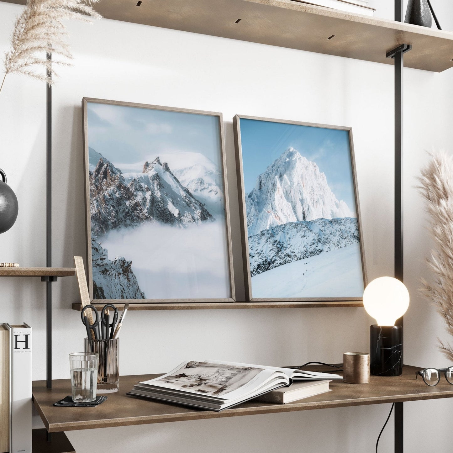 Minimalist desk setup featuring framed Aiguille du Midi and Grands Montets alpine prints.