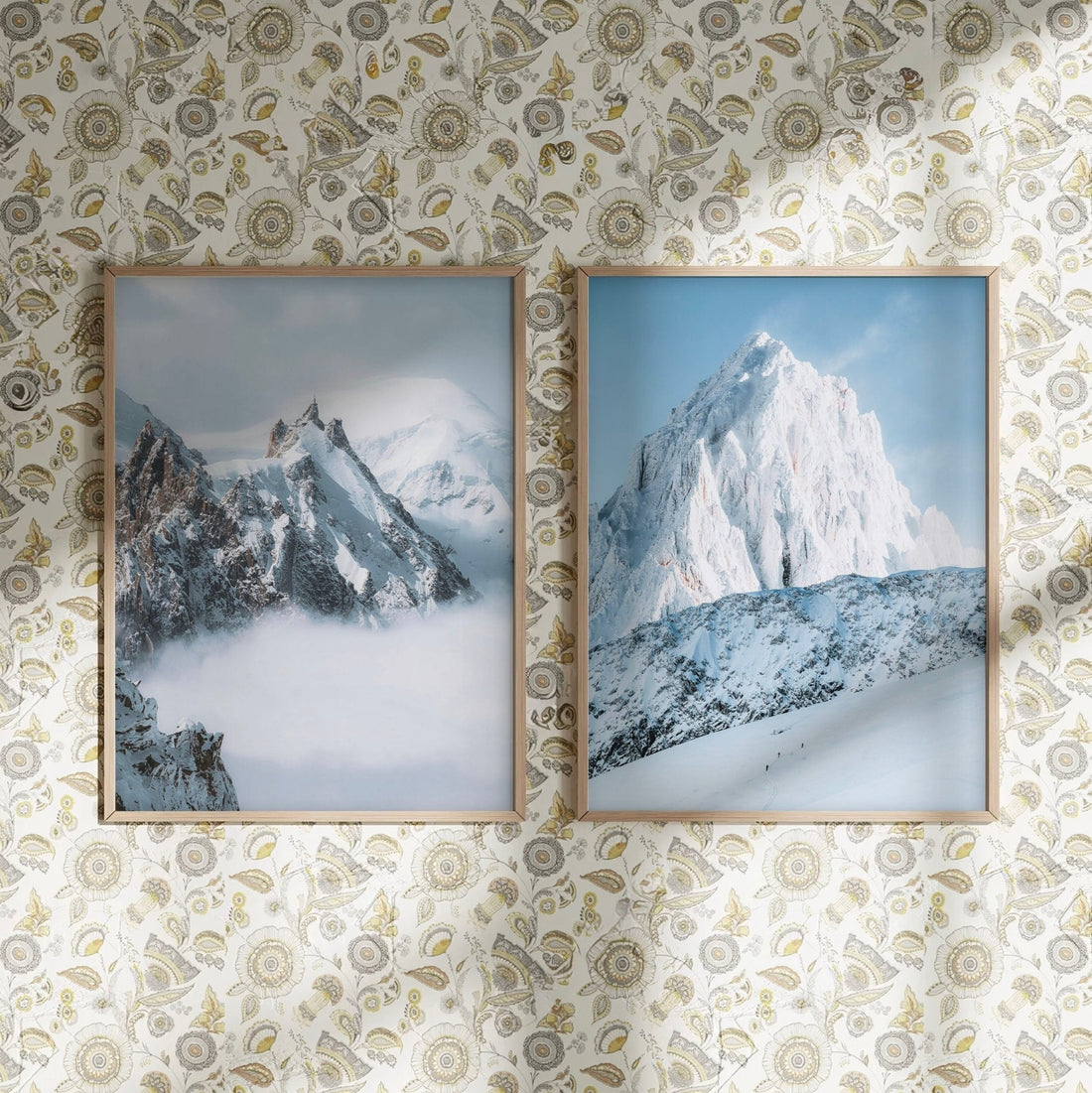 Stylish wall prints of Aiguille du Midi and Grands Montets against floral-patterned wallpaper.