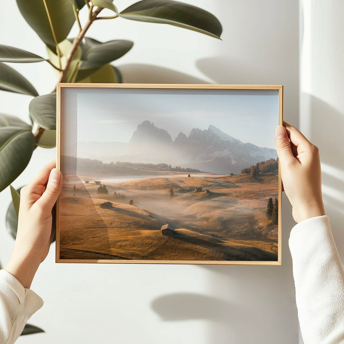 Framed Alpe di Siusi photo print with golden sunrise light and rustic alpine cabins in view.