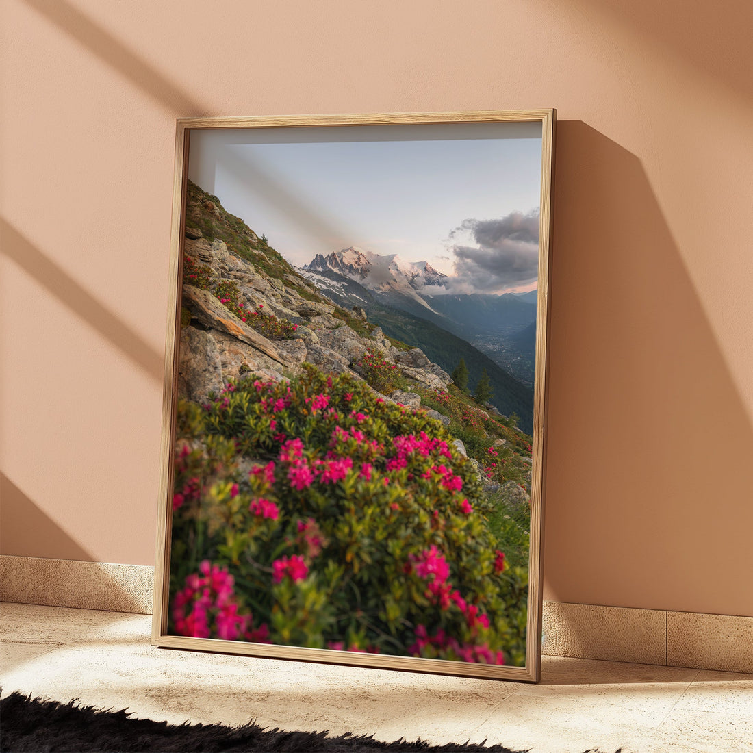 Scenic photography print of the French Alps, featuring a rocky mountain trail and blooming rhododendrons.