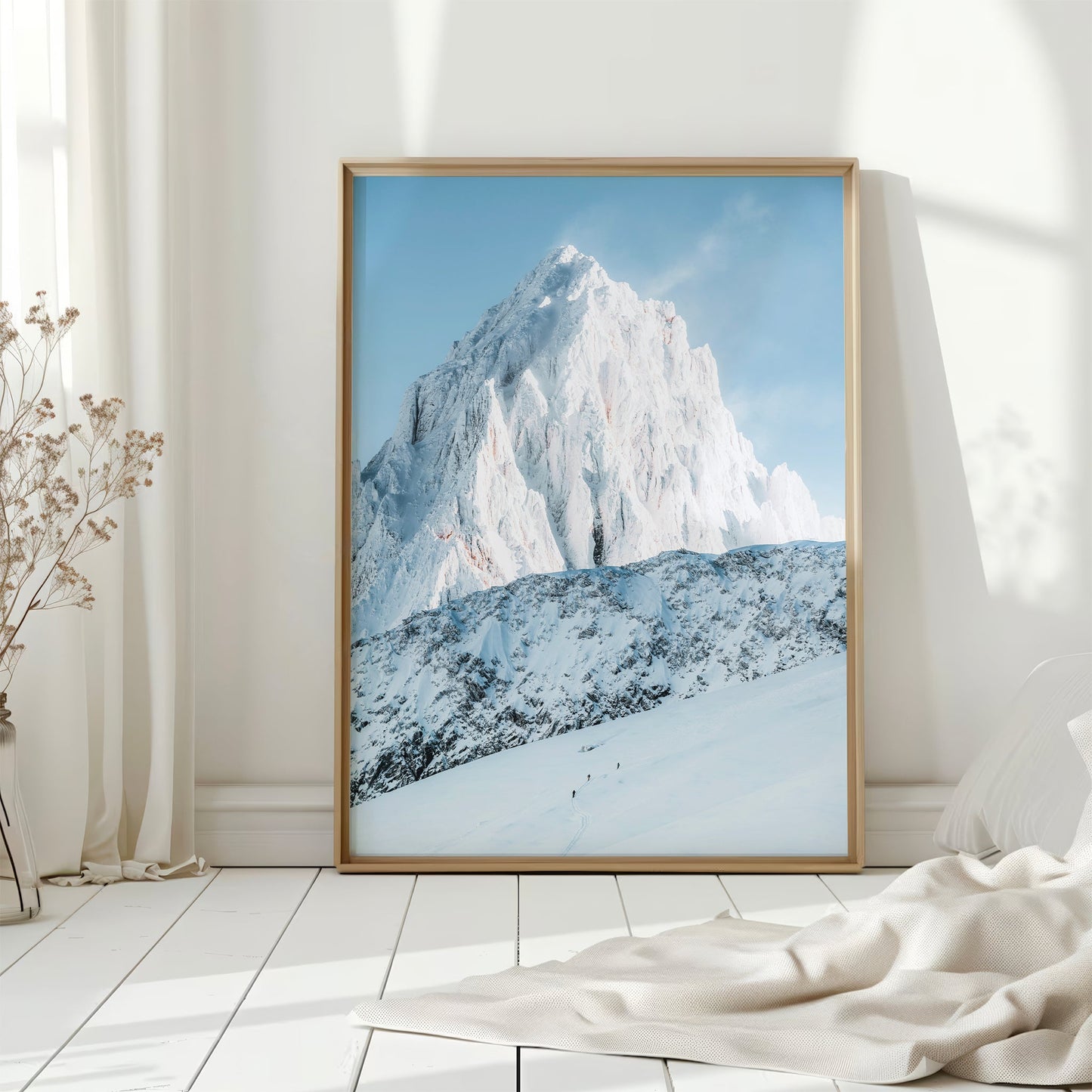 A breathtaking ski mountaineering photo of the French Alps, capturing climbers tackling high-altitude terrain.