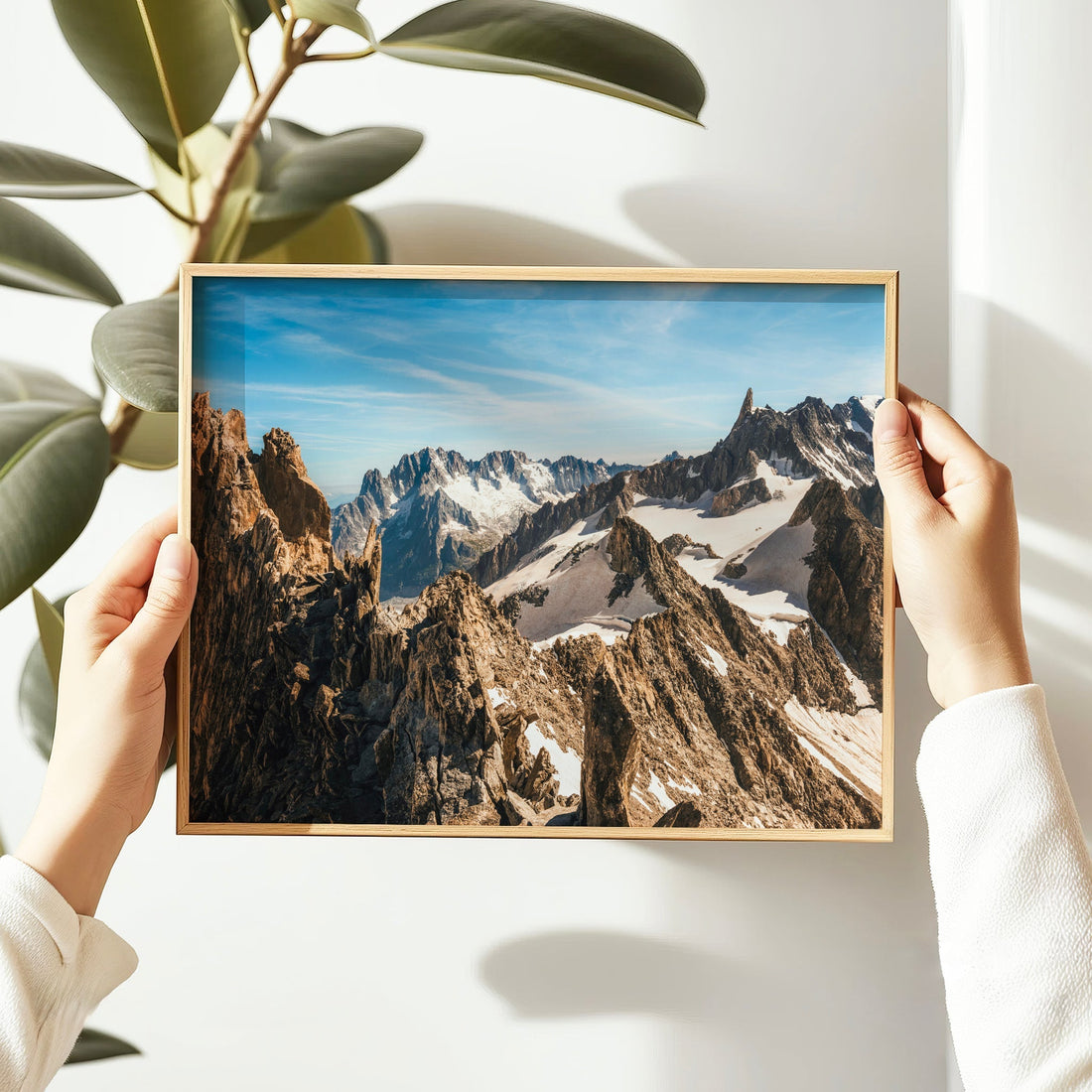 Striking snowy mountainscape print of the French Alps with bold rock formations and clear skies.