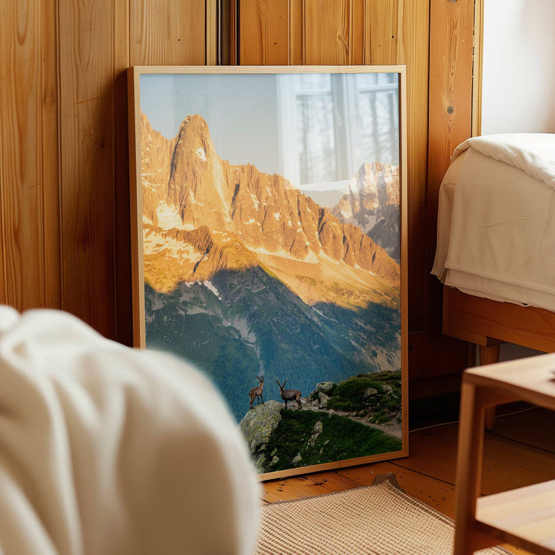 French Alps sunset wall art print featuring ibex standing atop a rocky peak under a golden sky.