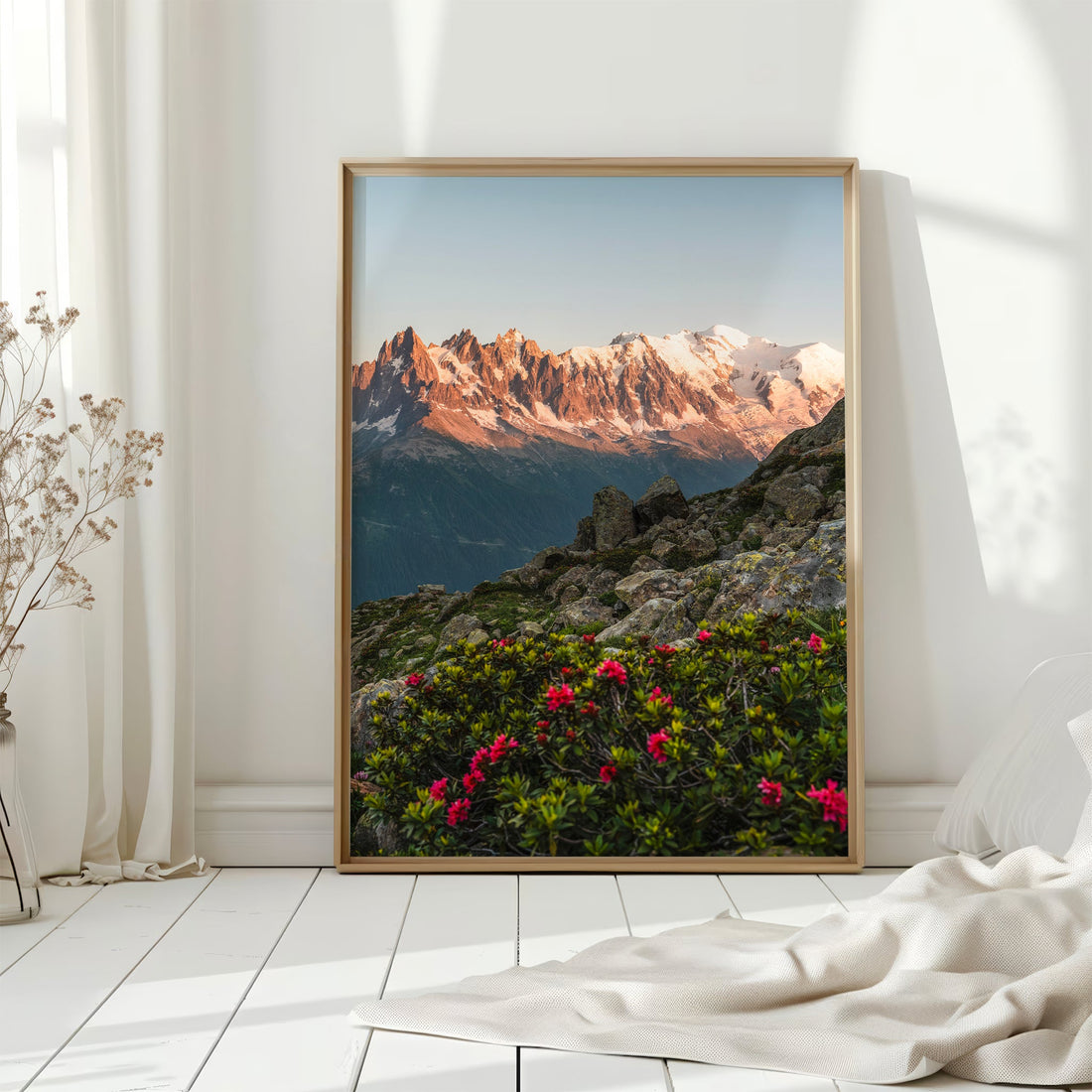 A striking photography print capturing the warm alpenglow over the jagged peaks of the French Alps.