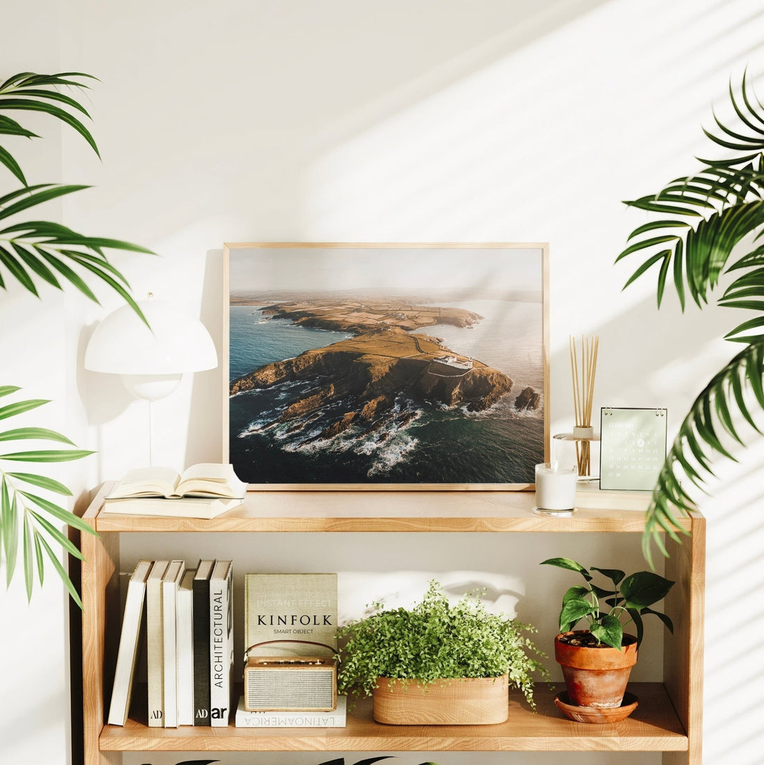 Irish lighthouse seascape print surrounded by plants and books