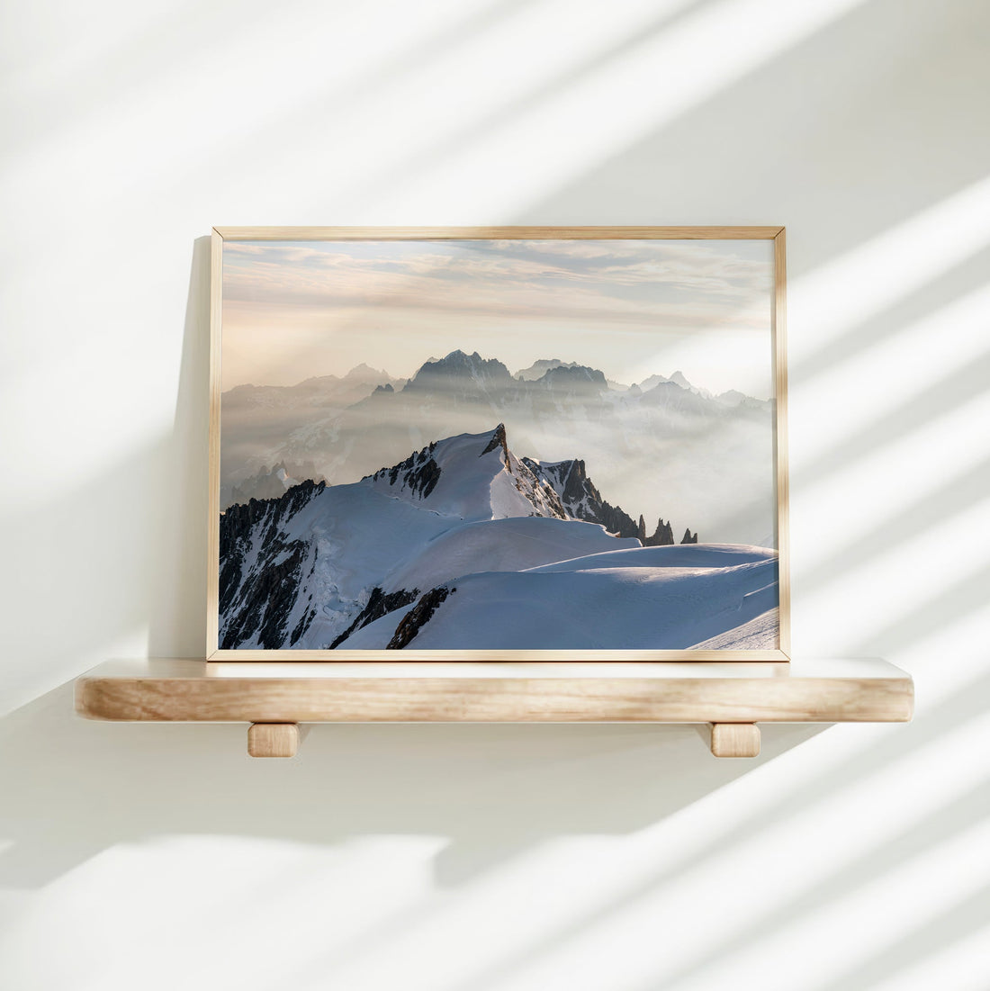 Glacier-covered Mont Maudit under a glowing alpine sunrise, fine art photography from Mont Blanc summit.