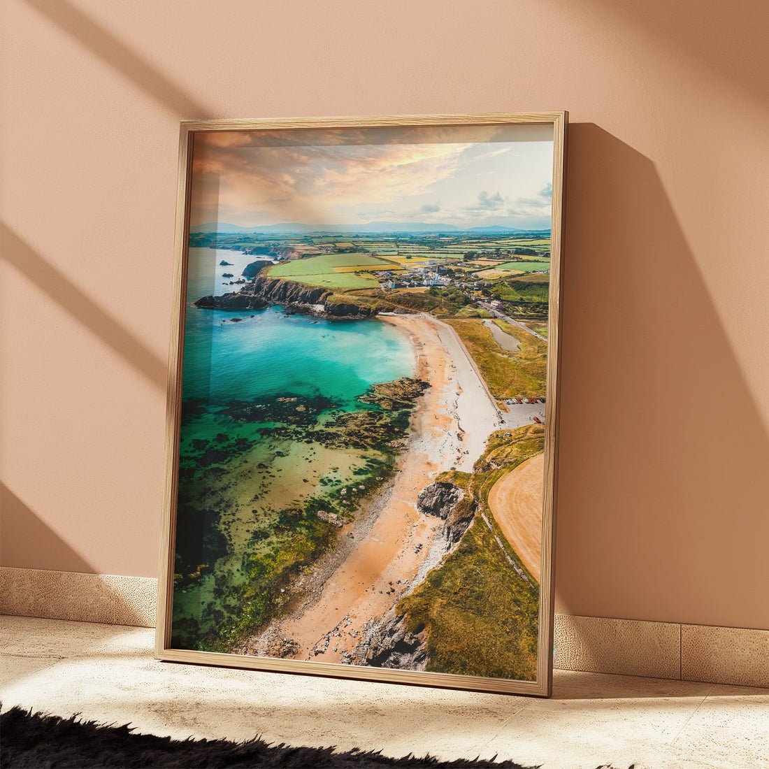 Annestown Beach photo print glowing in warm light against peach wall