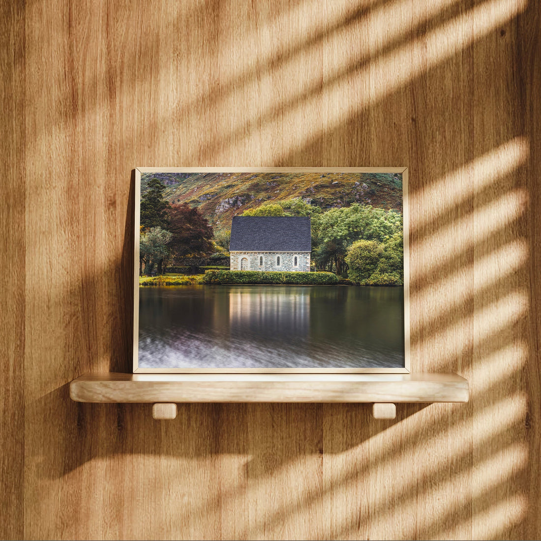 Gougane Barra print with soft shadows resting on a wooden shelf