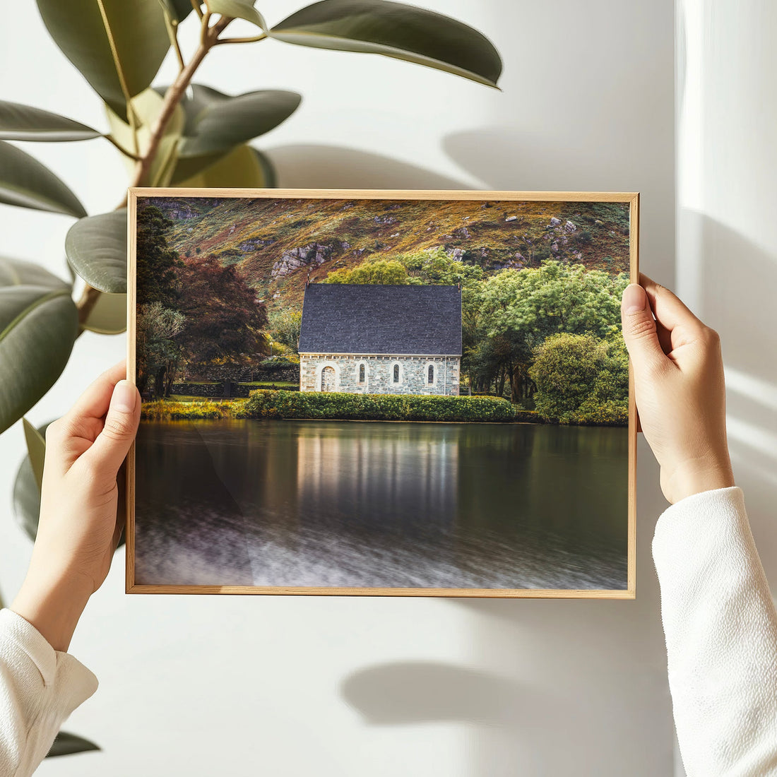 Holding a wooden frame featuring Gougane Barra landscape print