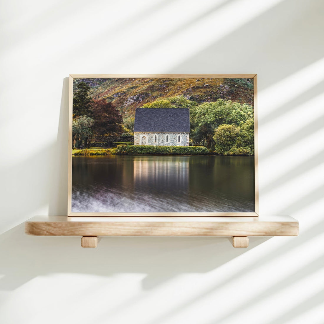 Gougane Barra framed photo on wall shelf with sunlit shadows