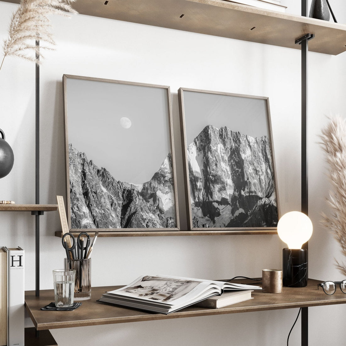 Grandes Jorasses photo print leaning on a minimalist wooden shelf with accessories.