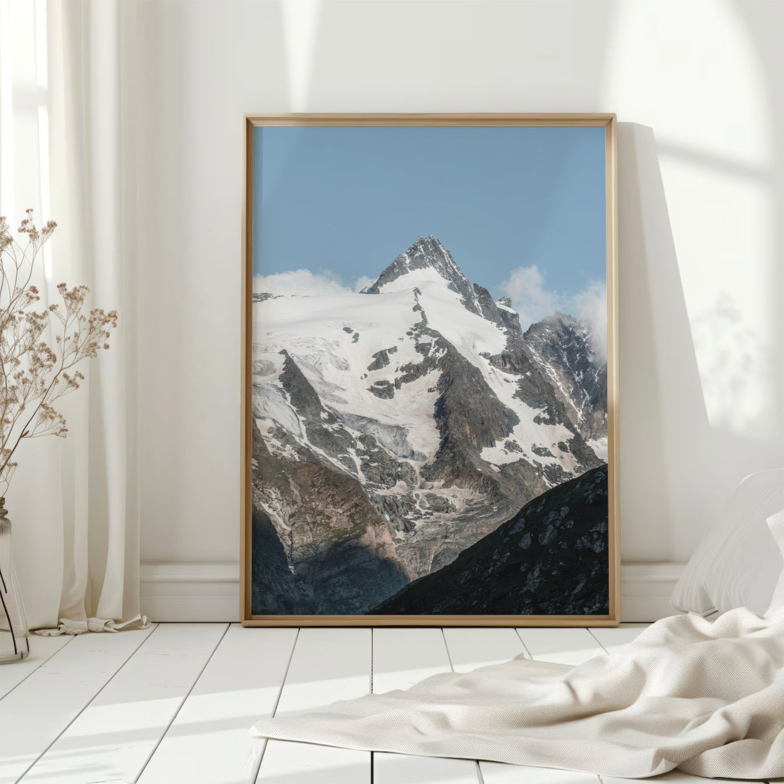 Large Grossglockner mountain wall art print leaning against bright white wall.